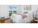 Cozy bedroom boasts waterfront views, natural light, and neutral decor creating a serene and inviting space at 9000 Commodore Dr # 606, Seminole, FL 33776