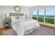Bedroom with a water view, plush carpet and a comfortable queen size bed at 9000 Commodore Dr # 606, Seminole, FL 33776