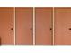 Four orange closet doors run along the wall in this home, providing plentiful storage space at 9000 Commodore Dr # 606, Seminole, FL 33776