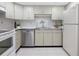 Functional kitchen equipped with white cabinets, stainless steel appliances, and ample counter space for meal preparation at 9000 Commodore Dr # 606, Seminole, FL 33776