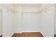 Spacious walk-in closet featuring wooden floors and wire shelving units for optimal storage and organization at 9000 Commodore Dr # 606, Seminole, FL 33776