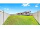 Spacious backyard with a well-maintained lawn and a vinyl fence, perfect for outdoor activities at 9293 Rally Spring Loop, Wesley Chapel, FL 33545