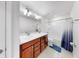 Bathroom featuring double vanity, bath and shower combo and tile flooring at 9293 Rally Spring Loop, Wesley Chapel, FL 33545