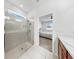 Bright bathroom featuring a tiled shower with glass door and neutral colors at 9293 Rally Spring Loop, Wesley Chapel, FL 33545