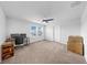 Bedroom boasts neutral carpet, dual monitors, and a modern ceiling fan at 9293 Rally Spring Loop, Wesley Chapel, FL 33545