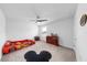 Bright bedroom showcases race car bed, ceiling fan, and carpeted floors at 9293 Rally Spring Loop, Wesley Chapel, FL 33545