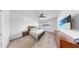 Cozy bedroom featuring carpet flooring, a ceiling fan, and a flat-screen television at 9293 Rally Spring Loop, Wesley Chapel, FL 33545