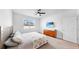 This bedroom offers neutral carpeting, TV and ample natural light at 9293 Rally Spring Loop, Wesley Chapel, FL 33545