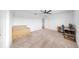 Bedroom featuring neutral carpet, office setup, and two large boxes at 9293 Rally Spring Loop, Wesley Chapel, FL 33545