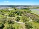 Aerial view of a community park featuring walking trails, mature trees, and recreational play areas for residents at 9293 Rally Spring Loop, Wesley Chapel, FL 33545