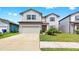 Charming two-story home with a well-maintained lawn and two-car garage at 9293 Rally Spring Loop, Wesley Chapel, FL 33545