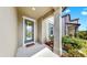 Welcoming front porch with decorative door and lush landscaping at 9293 Rally Spring Loop, Wesley Chapel, FL 33545