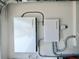 View of the home battery system with white metal casing, mounted on a garage wall at 9293 Rally Spring Loop, Wesley Chapel, FL 33545