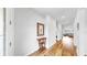 Inviting hallway with wood floors leading to living spaces at 9293 Rally Spring Loop, Wesley Chapel, FL 33545