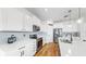 Spacious modern kitchen with stainless steel appliances, white cabinets, and hardwood floors at 9293 Rally Spring Loop, Wesley Chapel, FL 33545