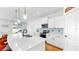Modern kitchen with a large island and barstool seating with stainless steel appliances and pendant lights at 9293 Rally Spring Loop, Wesley Chapel, FL 33545