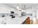 Beautiful kitchen featuring white cabinets, stainless steel appliances, pendant lighting, and a large center island with barstool seating at 9293 Rally Spring Loop, Wesley Chapel, FL 33545