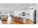 Modern kitchen with white cabinets, stainless steel appliances, and a large island at 9293 Rally Spring Loop, Wesley Chapel, FL 33545