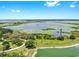 Scenic lake view showcasing the community's natural beauty with a walking trail, vegetation, and a tranquil atmosphere at 9293 Rally Spring Loop, Wesley Chapel, FL 33545