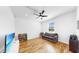 Open living space with hardwood floors, sofa, and television at 9293 Rally Spring Loop, Wesley Chapel, FL 33545
