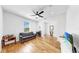 Living space with hardwood floors, sofa, and television at 9293 Rally Spring Loop, Wesley Chapel, FL 33545