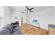 Open living space with hardwood floors, sofa, and television at 9293 Rally Spring Loop, Wesley Chapel, FL 33545