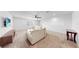 Upstairs living room featuring carpet flooring, a sectional couch, flat-screen television, and a ceiling fan at 9293 Rally Spring Loop, Wesley Chapel, FL 33545