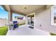 Covered patio with concrete floor, grill, and sliding glass door at 9293 Rally Spring Loop, Wesley Chapel, FL 33545