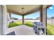 Covered patio with concrete floor, grill, and view of the fenced backyard at 9293 Rally Spring Loop, Wesley Chapel, FL 33545
