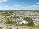 Aerial view of neighborhood amenities including a community pool, playground, and lush green spaces at 10233 Opaline Sky Pl, Riverview, FL 33578
