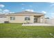 The backyard boasts a well-maintained lawn and patio, perfect for enjoying the outdoors at 10233 Opaline Sky Pl, Riverview, FL 33578