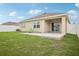 Enjoy this home's serene backyard with a patio and green lawn; ideal for outdoor relaxation at 10233 Opaline Sky Pl, Riverview, FL 33578