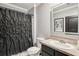 Clean bathroom features a shower with black curtain, neutral color scheme, and functional design at 10233 Opaline Sky Pl, Riverview, FL 33578