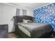 Bedroom with luxury furniture, hardwood floors, and an accent wall at 10233 Opaline Sky Pl, Riverview, FL 33578