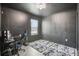 Contemporary bedroom with dark walls, laminate floors, and a sleek gaming setup at 10233 Opaline Sky Pl, Riverview, FL 33578