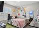 Comfortable bedroom with natural light, playful decor, and a cozy atmosphere at 10233 Opaline Sky Pl, Riverview, FL 33578
