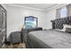 This bedroom boasts a modern gray color scheme with a plush, luxurious bed at 10233 Opaline Sky Pl, Riverview, FL 33578