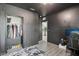 Stylish room with dark paint, laminate floors, and a glimpse into a closet and bathroom at 10233 Opaline Sky Pl, Riverview, FL 33578