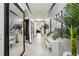 Bright hallway decorated with modern art and decorative plants at 10233 Opaline Sky Pl, Riverview, FL 33578