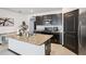 Well-lit kitchen with granite countertops, stainless steel appliances, and ample cabinet space at 10233 Opaline Sky Pl, Riverview, FL 33578