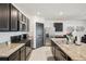 Modern kitchen featuring granite countertops, stainless steel appliances, and dark wood cabinets at 10233 Opaline Sky Pl, Riverview, FL 33578