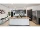 Open kitchen with granite countertops, stainless steel appliances, and a large island at 10233 Opaline Sky Pl, Riverview, FL 33578