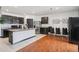 Modern kitchen features stainless steel appliances, granite countertops, and a breakfast bar at 10233 Opaline Sky Pl, Riverview, FL 33578
