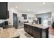 Modern kitchen with stainless appliances and a granite island overlooking the dining area at 10233 Opaline Sky Pl, Riverview, FL 33578
