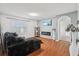 Comfortable living room with wood floors, built-in fireplace, and large window at 10233 Opaline Sky Pl, Riverview, FL 33578