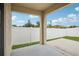 This covered patio offers a view of the fenced yard, providing a private outdoor space at 10233 Opaline Sky Pl, Riverview, FL 33578