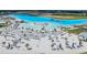 Lagoon features a pristine sandy beach with palm trees, lounge seating, and shallow swimming access at 10381 Tupper Cay Dr, San Antonio, FL 33576