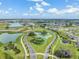 Expansive aerial view of the community surrounded by lakes and lush landscaping at 10381 Tupper Cay Dr, San Antonio, FL 33576