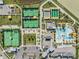 An aerial view showcasing community amenities including pools, tennis courts, and recreational areas at 10381 Tupper Cay Dr, San Antonio, FL 33576