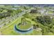Community aerial showing landscaping, water feature, and surrounding wetlands at 10381 Tupper Cay Dr, San Antonio, FL 33576